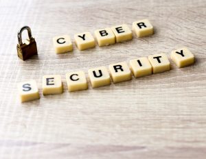 Cyber security lettering with padlock on wooden table